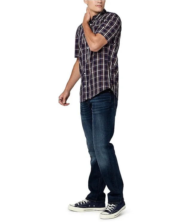 Man in Blue and White Plaid Shirt and Denim Jeans Standing on