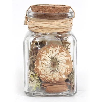cork topped glass bottle with faux plants