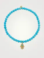 Beaded Turquoise Bracelet With 14K Gold Small Rainbow Hamsa Charm