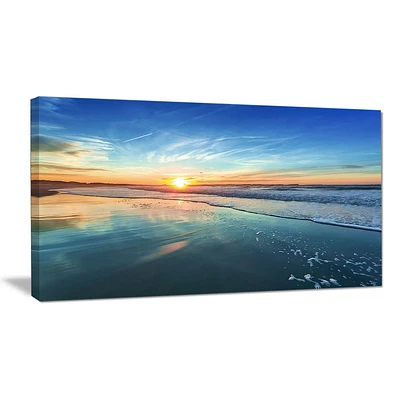 Design Art Blue Seashore with Distant Sunset Seashore Canvas Wall Art