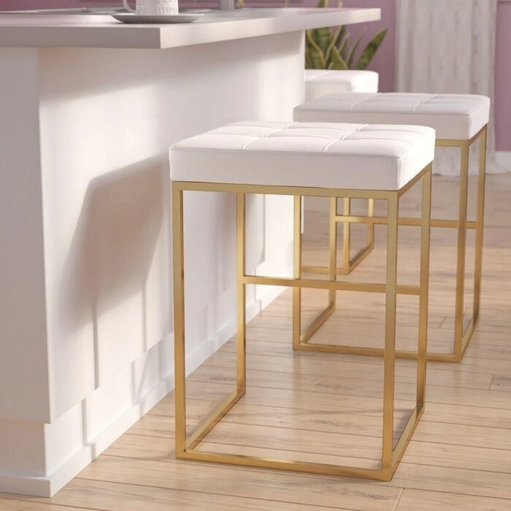 PIPE II COUNTER STOOL with tufted cushion and brushed gold stainless steel frame.