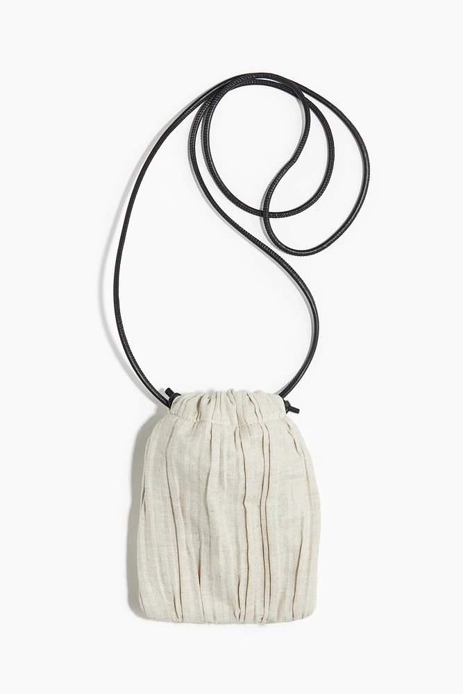 Linen-blend drawstring phone bag