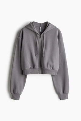 Veste courte avec capuchon et glissière