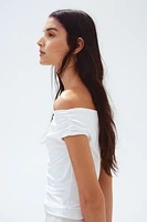 Haut épaules nues à effet drapé