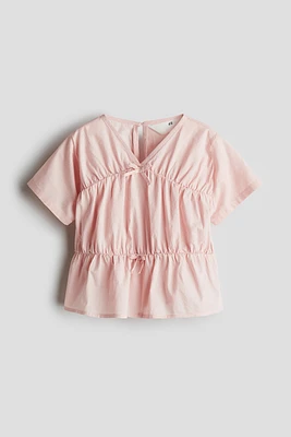Blouse péplum en coton
