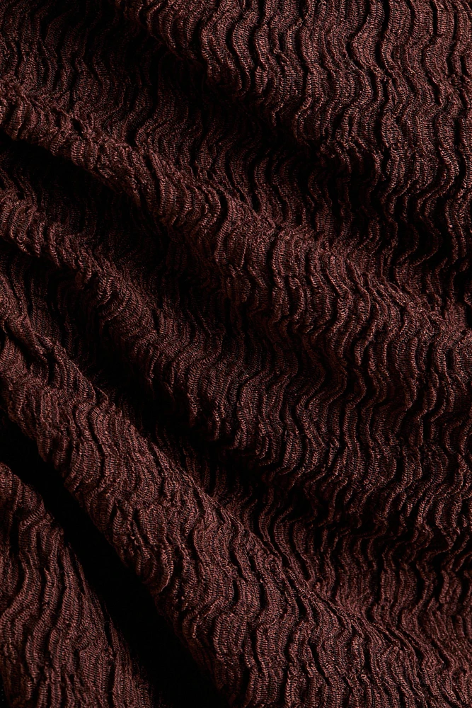 Robe moulante à effet drapé