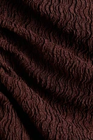 Robe moulante à effet drapé
