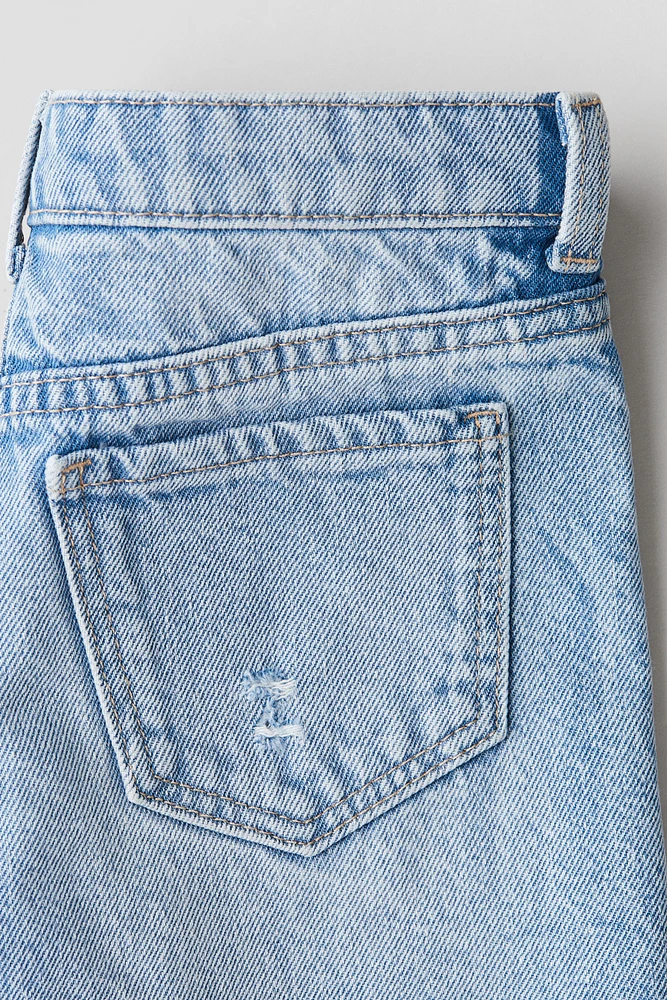 Short frangé en denim