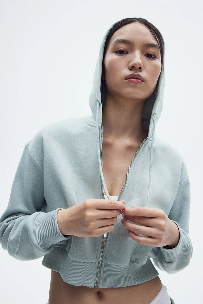 Veste courte avec capuchon et glissière