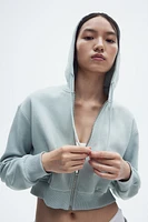 Veste courte avec capuchon et glissière
