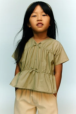 Blouse péplum en coton