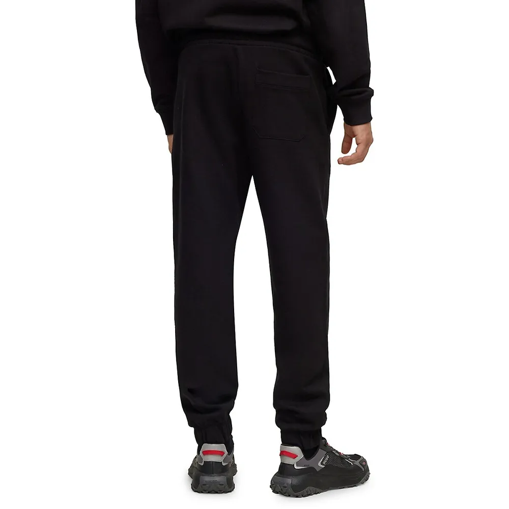 Relaxed Stacked Embossed Logo Trackpants