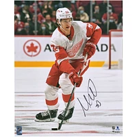 Moritz Seider Detroit Red Wings Autographed 16" x 20" Skating with Puck Photograph