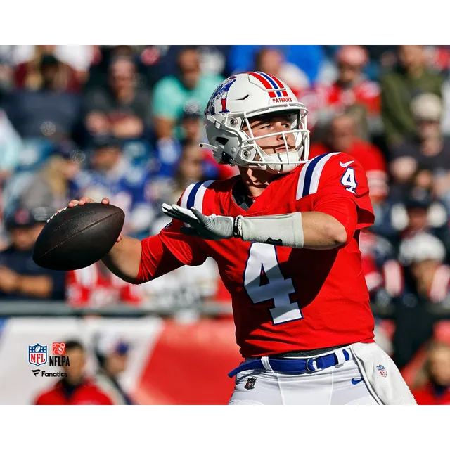 Mac Jones New England Patriots Unsigned Throwing Pass Vertical Photograph