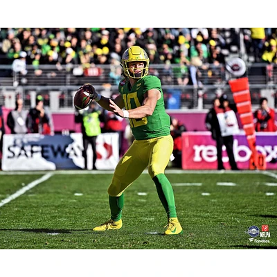 Justin Herbert Oregon Ducks Unsigned Green Jersey Throwing Photograph
