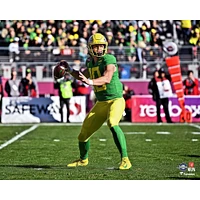 Justin Herbert Oregon Ducks Unsigned Green Jersey Throwing Photograph