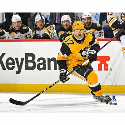 Bryan Rust Pittsburgh Penguins Unsigned Gold Alternate Jersey Skating vs. Boston Bruins Photograph