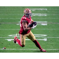 Christian McCaffrey San Francisco 49ers Unsigned Runs The Ball in Scarlet Jersey Photograph