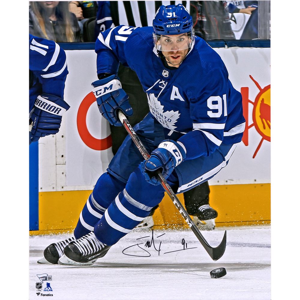 John Tavares Toronto Maple Leafs Autographed 16" x 20" Blue Jersey Skating with Puck Photograph