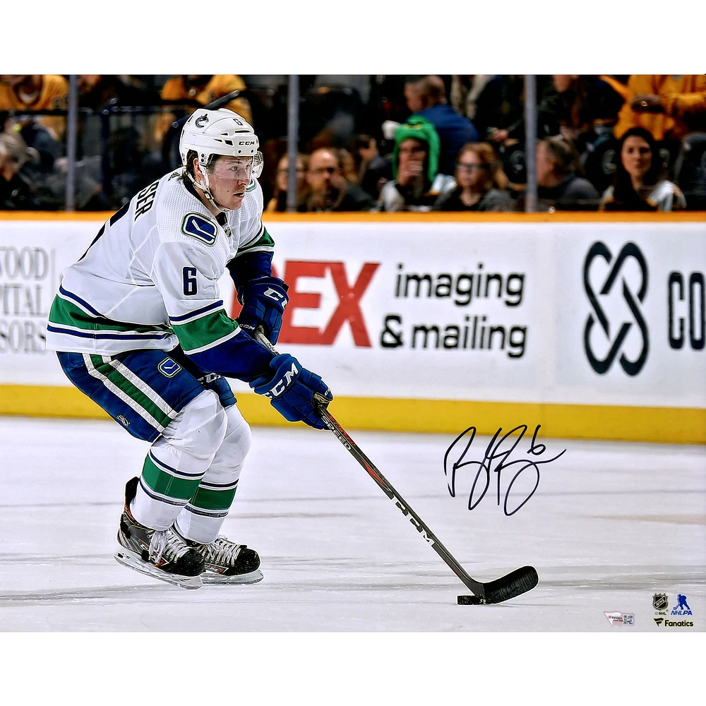 Brock Boeser Vancouver Canucks Autographed 16" x 20" White Jersey Skating with Puck Photograph