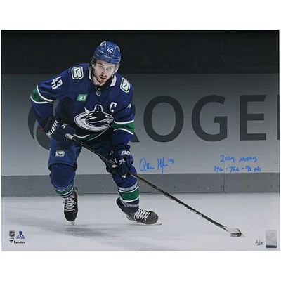 Quinn Hughes Vancouver Canucks Autographed 16" x 20" Blue Jersey Spotlight Photograph with "2024 Norris" & "17G - 75A - 92 Pts" Inscriptions - Limited Edition of 24