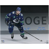Quinn Hughes Vancouver Canucks Autographed 16" x 20" Blue Jersey Spotlight Photograph with "2024 Norris" & "17G - 75A - 92 Pts" Inscriptions - Limited Edition of 24