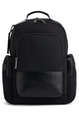 Multi-pocket backpack with monogram address tag