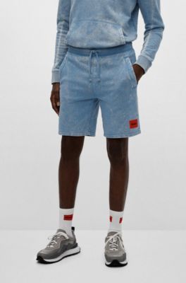 Powder-dyed shorts with red logo label