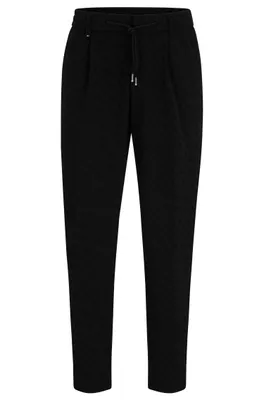 Pantalon Relaxed Fit en matière stretch à monogrammes