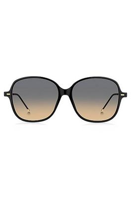 Lunettes de soleil en acétate noir avec branches dorées et chaîne