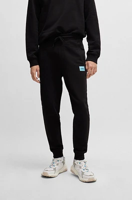 Cotton-terry tracksuit bottoms with red logo label
