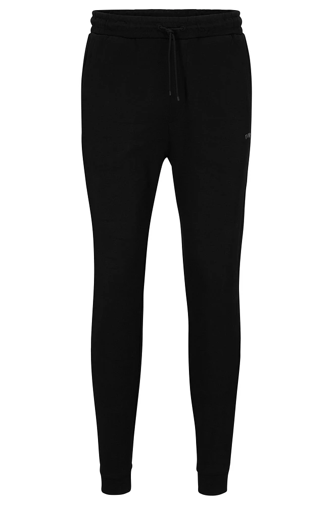 Cotton tracksuit bottoms with curved logo