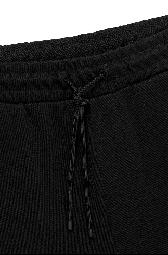 Cotton tracksuit bottoms with curved logo