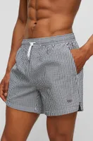 Seersucker striped swim shorts with logo badge