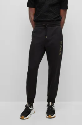 HUGO - Monogram-print tracksuit bottoms with striped tape