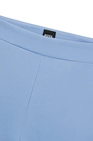 Pantalones regular fit en tejido elástico con corte cónico