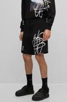 Relaxed-fit cotton shorts with graffiti-inspired logo