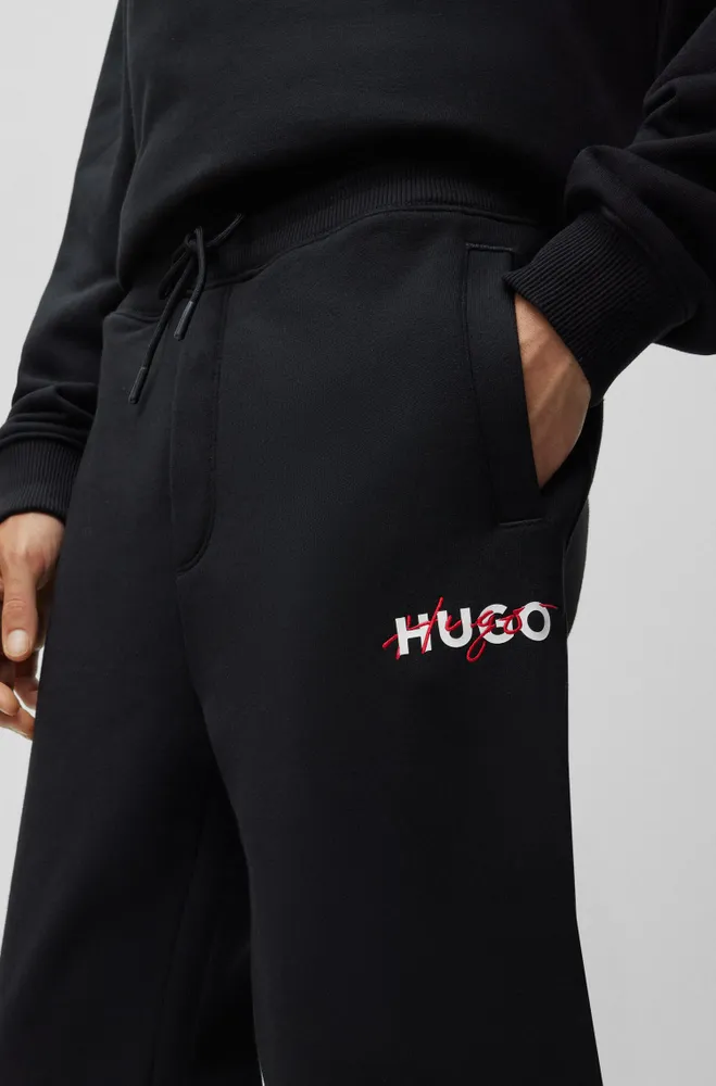 BOSS - Monogram-print tracksuit bottoms with signature-stripe tape