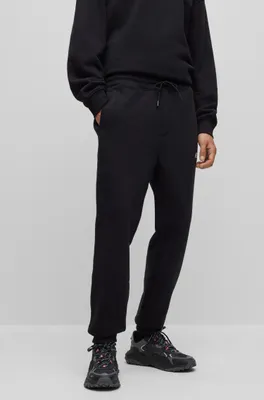 BOSS - Monogram-print tracksuit bottoms with signature-stripe tape