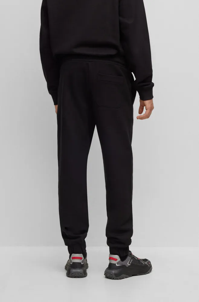 HUGO Relaxed-fit cotton-terry tracksuit bottoms with stacked logo