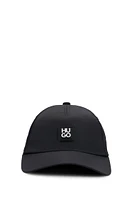 Waterproof cap with metallic stacked logo