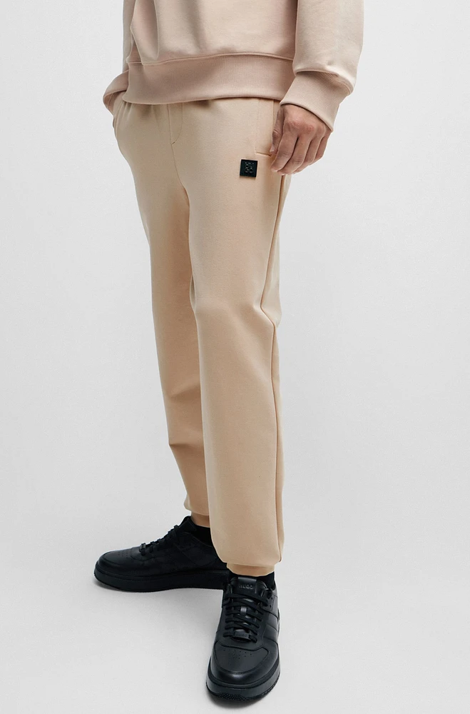 Pantalones de chándal en felpa algodón elástico con logo apilado