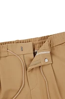 Pantalones relaxed fit de tejido elástico con cordón en la cintura