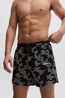 Fully lined swim shorts with all-over logos