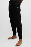 Tracksuit bottoms with stripes and logos