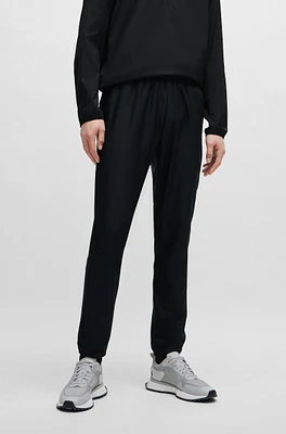 Tracksuit bottoms stretch fabric with decorative reflective logo