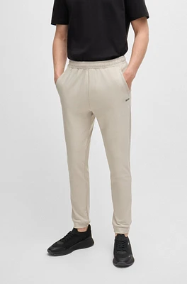 Tracksuit bottoms stretch fabric with decorative reflective logo