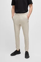 Tracksuit bottoms stretch fabric with decorative reflective logo