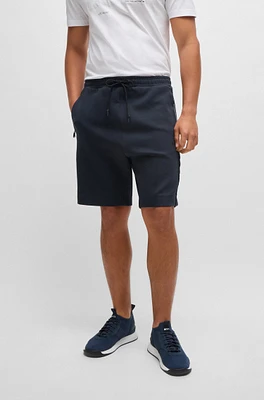 Stretch-cotton shorts with embossed artwork