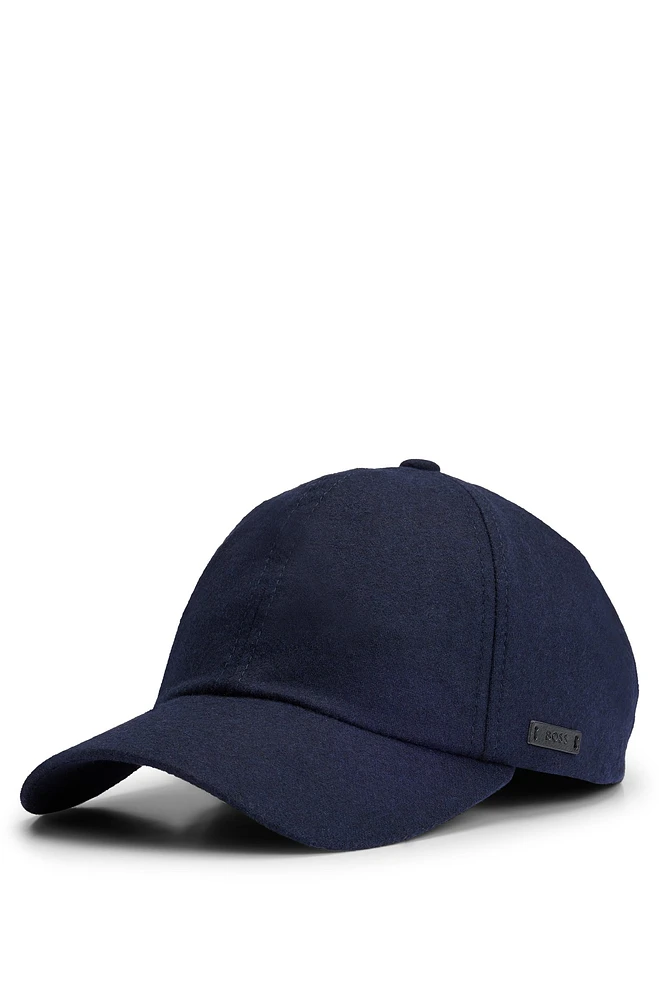 Wool cap with faux-leather logo label